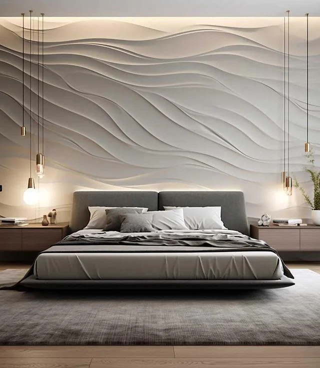 Bedroom with a sculpted 3D wave wall panel and pendant lighting above the bed
